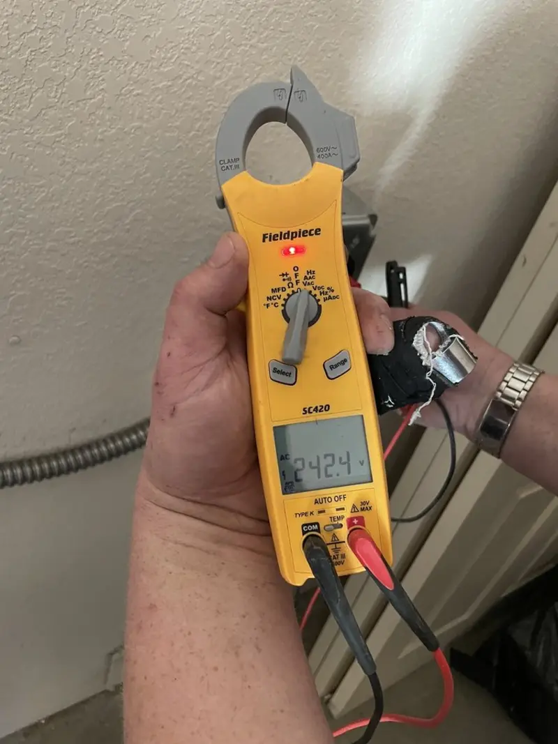 Voltage testing with clamp meter during Electrical Installation Services in Sterling
